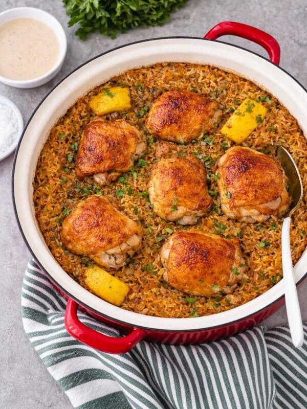 Chicken and rice dish in pot with lemon tahini sauce