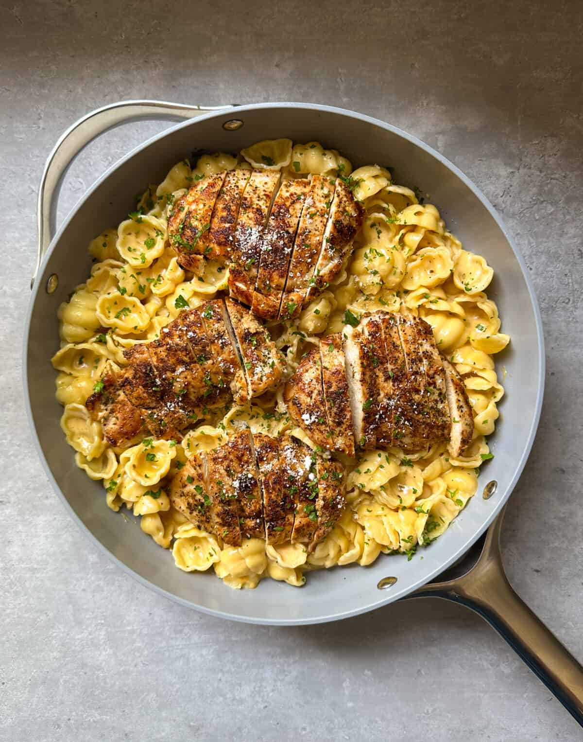 Chicken breasts in pasta with herbs and cheese.