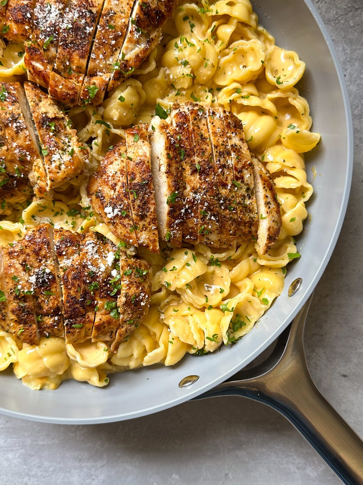Chicken breasts in pasta with parmesan cheese.