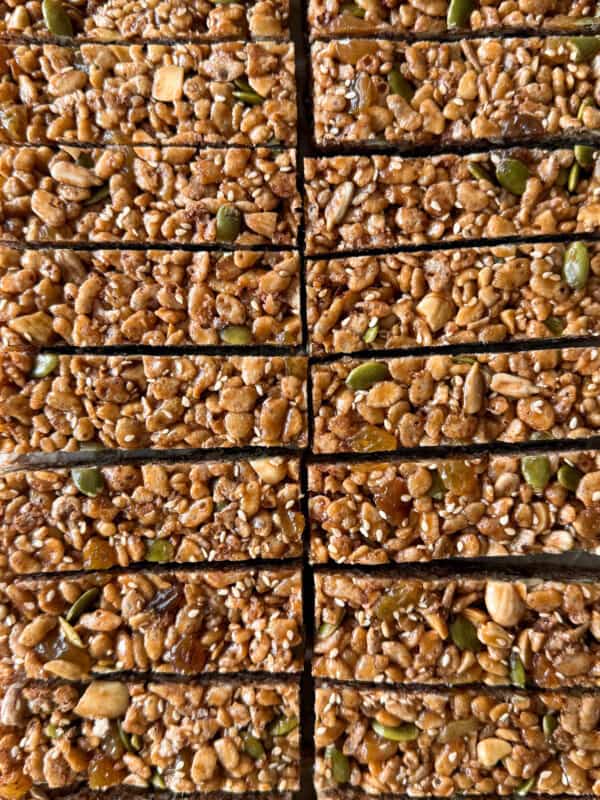 Close-up of 16 rectangular Breakfast Bars with visible seeds, nuts, and grains, arranged in a neat grid pattern—perfect inspiration for your next Breakfast Bars Recipe.