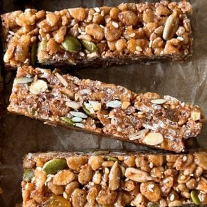 Close-up of homemade Breakfast Bars with visible oats, seeds, nuts, and raisins, arranged on parchment paper—an irresistible Breakfast Bars Recipe for a wholesome start to your day.